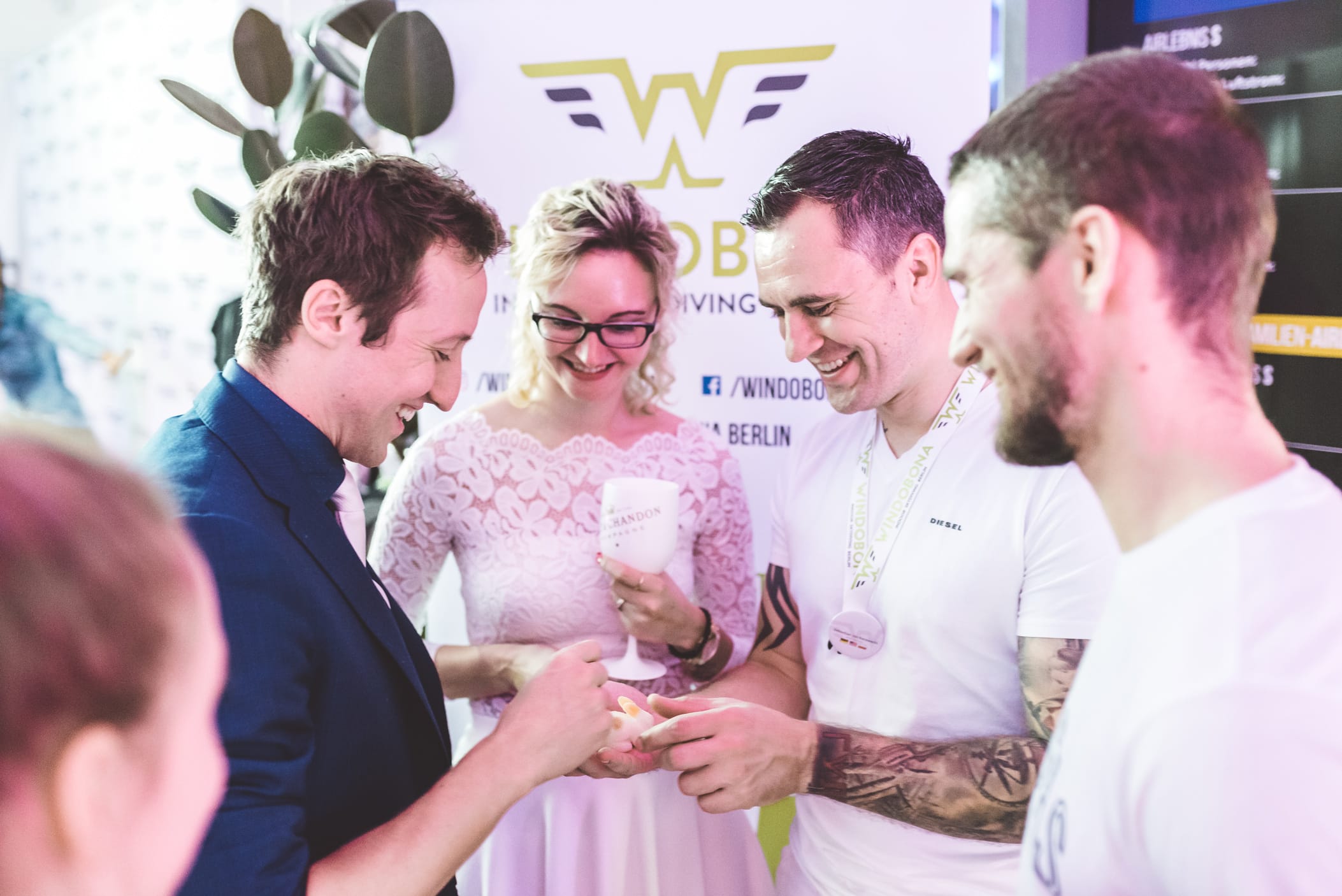 A magician showing a magic trick at a networking party.